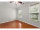 Bedroom features hardwood floors, ceiling fan, and natural light from two windows at 1708 Waterbrook Dr, Charleston, SC 29414