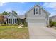 Inviting home with a two-car garage, well-maintained lawn, and classic design elements at 1708 Waterbrook Dr, Charleston, SC 29414