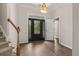 Inviting foyer with hardwood floors, decorative front door, and adjacent staircase at 1708 Waterbrook Dr, Charleston, SC 29414