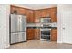 Well-lit kitchen featuring stainless steel appliances and stylish wood cabinetry at 1708 Waterbrook Dr, Charleston, SC 29414