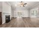 Spacious living room with fireplace, hardwood floors, and French doors to bright sunroom at 1708 Waterbrook Dr, Charleston, SC 29414