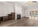 Spacious living room featuring a cozy fireplace, hardwood floors, and French doors to sunroom at 1708 Waterbrook Dr, Charleston, SC 29414