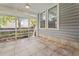 Relaxing screened porch with tile flooring, ceiling fan, and views of the surrounding landscape at 1708 Waterbrook Dr, Charleston, SC 29414