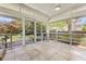 Bright screened porch with tile flooring and views of the backyard and lush greenery at 1708 Waterbrook Dr, Charleston, SC 29414