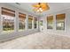 Bright sunroom features tile floors, multiple windows and ceiling fan at 1708 Waterbrook Dr, Charleston, SC 29414