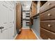 Spacious walk-in closet features custom shelving and wood floors for organization at 1708 Waterbrook Dr, Charleston, SC 29414