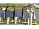 An aerial view showcases several homes with well-manicured lawns, driveways, and dark gray shingles at 172 Helena Park Dr, Summerville, SC 29486