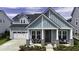 Charming two-story home featuring a covered front porch, a well-maintained lawn, and an attached two-car garage at 172 Helena Park Dr, Summerville, SC 29486
