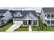 Inviting home with a covered porch, manicured lawn, attached garage, and charming curb appeal in a residential neighborhood at 172 Helena Park Dr, Summerville, SC 29486