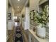 Hallway features neutral paint, wood-look floors, elegant wainscoting, tasteful decor, and ample natural light at 172 Helena Park Dr, Summerville, SC 29486