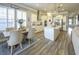 Bright kitchen with white cabinets, stainless steel appliances, island, and dining area at 172 Helena Park Dr, Summerville, SC 29486
