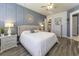 Spacious main bedroom with blue accent wall, ceiling fan, and hardwood floors at 172 Helena Park Dr, Summerville, SC 29486