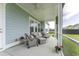 Spacious screened-in porch featuring an outdoor seating area and fan at 172 Helena Park Dr, Summerville, SC 29486