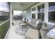Relaxing screened-in porch with comfortable seating and view of backyard at 172 Helena Park Dr, Summerville, SC 29486