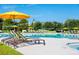 Tranquil poolside setting with lounge chairs, umbrellas, and a clear, refreshing swimming pool at 172 Helena Park Dr, Summerville, SC 29486