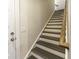 Open staircase featuring painted risers, wooden treads, and a natural wood railing at 172 Helena Park Dr, Summerville, SC 29486