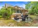 Beautiful backyard with a large patio, a fountain, an outdoor kitchen area, and mature trees at 1721 Bowline Dr, Mount Pleasant, SC 29466
