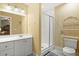 Well-lit bathroom features a glass enclosed shower, a vanity with storage, and a toilet at 1721 Bowline Dr, Mount Pleasant, SC 29466