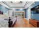 View of a bright bedroom with tray ceilings, wood floors, and access to a sunroom at 1721 Bowline Dr, Mount Pleasant, SC 29466