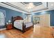 Bright bedroom featuring tray ceilings, wood floors, and sliding doors to a sunroom at 1721 Bowline Dr, Mount Pleasant, SC 29466