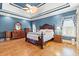 Spacious bedroom with wood floors, tray ceilings, and a decorative wood bed frame at 1721 Bowline Dr, Mount Pleasant, SC 29466