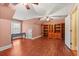 Open bonus room with wood floors, a built-in bookshelf, desk, and a ceiling fan at 1721 Bowline Dr, Mount Pleasant, SC 29466
