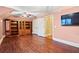 Spacious bonus room with a ceiling fan, hardwood floors, and a large built-in cabinet for storing books at 1721 Bowline Dr, Mount Pleasant, SC 29466