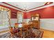 Elegant dining room with rich red walls, white wainscoting, and a classic wooden dining set at 1721 Bowline Dr, Mount Pleasant, SC 29466