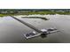 Stunning aerial view of a private dock with boat slips on the water and a long wooden bridge at 1721 Bowline Dr, Mount Pleasant, SC 29466