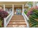 Inviting front porch with brick steps, white railings, and colorful landscaping at 1721 Bowline Dr, Mount Pleasant, SC 29466