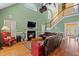 Inviting living room with a fireplace and staircase leading to the second floor and large windows at 1721 Bowline Dr, Mount Pleasant, SC 29466