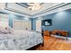 Main bedroom with tray ceiling, hardwood floors, and a TV at 1721 Bowline Dr, Mount Pleasant, SC 29466