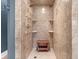 Tiled walk-in shower featuring dual shower heads, built-in shelves, and a wood bench at 1721 Bowline Dr, Mount Pleasant, SC 29466