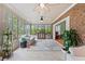 Sunroom with large windows, brick accent wall, and access to different areas of the house at 1721 Bowline Dr, Mount Pleasant, SC 29466