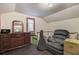 Attic space with dark wood dresser, vintage mirror, lounger chair, and a black guitar case at 1830 Kempton Ave, James Island, SC 29412