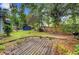 Spacious backyard featuring a wooden deck, established lawn, wooden fence, and a quaint blue shed at 1830 Kempton Ave, James Island, SC 29412