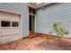 Backyard with brick patio, blue siding, a garage, and a small tree at 1830 Kempton Ave, James Island, SC 29412