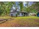 Exterior view of the light blue house shows a spacious backyard and covered patio at 1830 Kempton Ave, James Island, SC 29412
