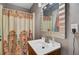 Bathroom featuring a wood vanity with sink, a patterned shower curtain, and neutral walls at 1830 Kempton Ave, James Island, SC 29412