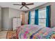 Bedroom features large window with blue curtains, a bed with colorful bedding, and white dresser at 1830 Kempton Ave, James Island, SC 29412