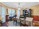Elegant dining room featuring a chandelier, wallpaper, hardwood floors, and large windows at 1830 Kempton Ave, James Island, SC 29412