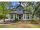 Charming two-story home with light blue siding, bay windows, brick walkway, and mature landscaping at 1830 Kempton Ave, James Island, SC 29412
