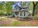 Charming two-story home with light blue siding, bay windows, white picket fence, and mature landscaping at 1830 Kempton Ave, James Island, SC 29412