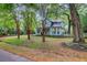 Two-story home with light blue siding, bay windows, mature landscaping, and tall crepe myrtle trees at 1830 Kempton Ave, James Island, SC 29412
