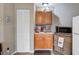 This kitchen features wood cabinets, stainless steel sink and faucet, and stainless steel microwave at 1830 Kempton Ave, James Island, SC 29412