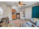 Compact kitchen area features wood cabinets, mini-fridge, and a ceiling fan with light fixture at 1830 Kempton Ave, James Island, SC 29412