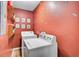 Laundry room with red walls includes a washing machine and dryer at 1830 Kempton Ave, James Island, SC 29412