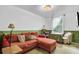 A living room features an orange sofa, lamps, a window, and a decorative light fixture at 1830 Kempton Ave, James Island, SC 29412