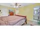 Bright main bedroom with ceiling fan, television, and ensuite bathroom access at 1830 Kempton Ave, James Island, SC 29412