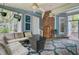 This screened porch has blue walls and includes an outdoor sectional sofa and a table at 1830 Kempton Ave, James Island, SC 29412